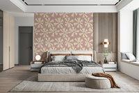 Mid-century inspired wallpaper with abstract pinwheel flowers in cream against a soft pink backdrop.