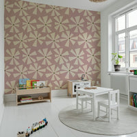 Geometric floral wallpaper featuring stylized cream starburst shapes in a retro pink tone.