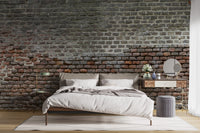 Soiled Dirt & Rustic Brick wallpaper mural styled as a living room feature wall behind a sofa and seating in brown tones