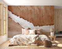 Rustic Horizon Textured wallpaper mural in rust and white plaster behind a bed with cream bedding in a bedroom