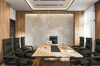Rustic World Map wallpaper in soft beige behind a long wood conference table and black office chairs in a boardroom