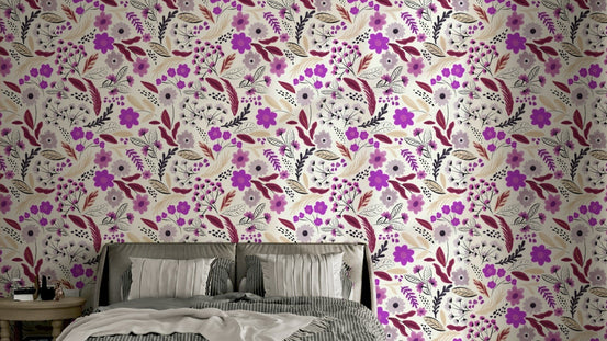 Rustic Rose Garden botanicals wallpaper in magenta and burgundy on cream behind a bed with grey striped pillows