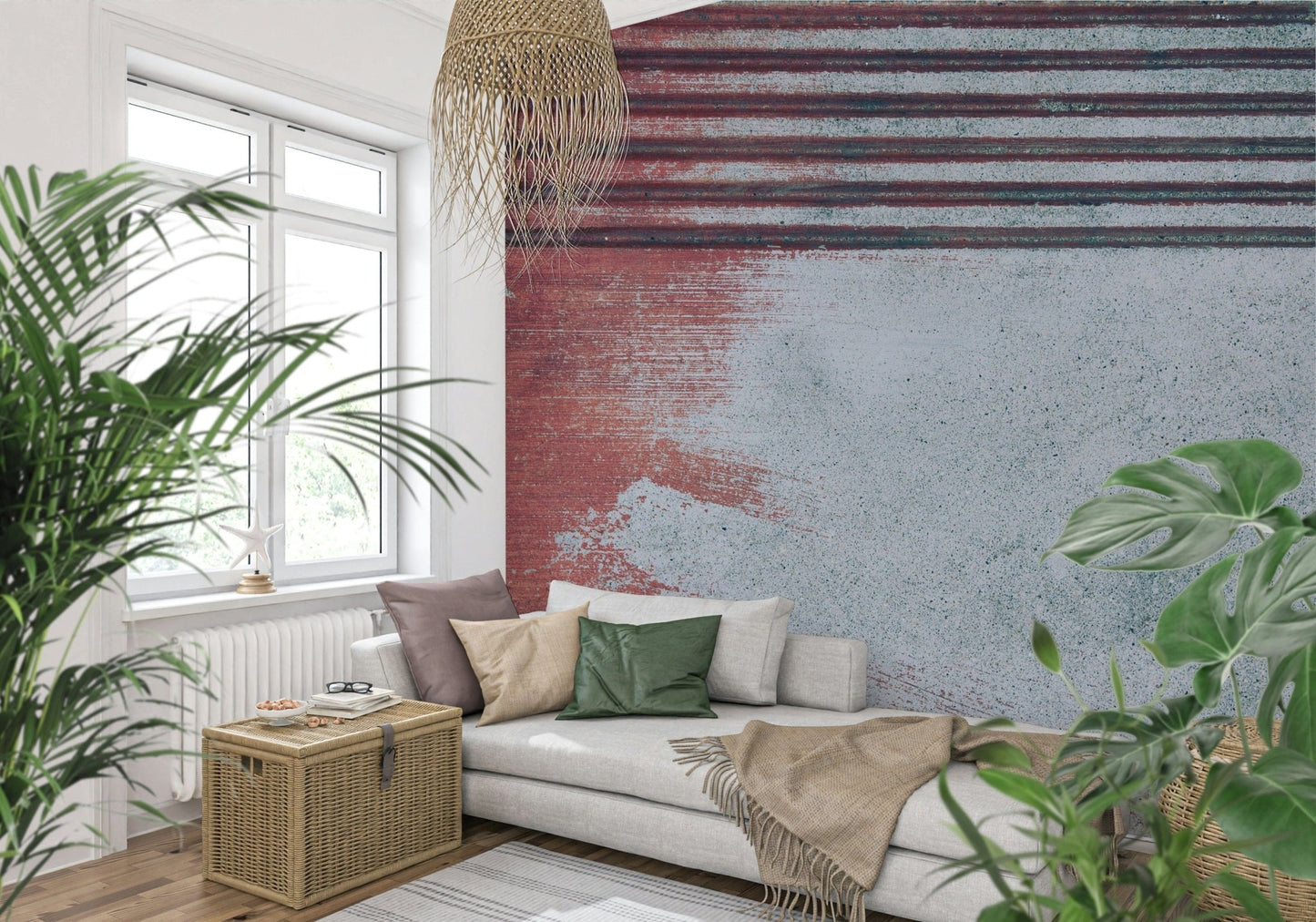 Rustic Rouge Concrete wallpaper mural in red and gray behind a white sofa and woven pendant among plants