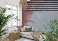 Rustic Rouge Concrete wallpaper mural in red and gray behind a white sofa and woven pendant among plants