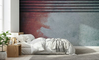 Rustic Rouge Concrete wallpaper mural in red and gray behind a white bed and wood nightstand in a bedroom