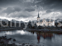Sacred Shores wallpaper mural shown as a full-wall mural of a white steepled church by a lake under a stormy grey sky
