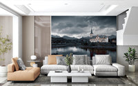 Sacred Shores wallpaper mural of a church and grey sky behind a white sectional and tan chaise in a spacious living room
