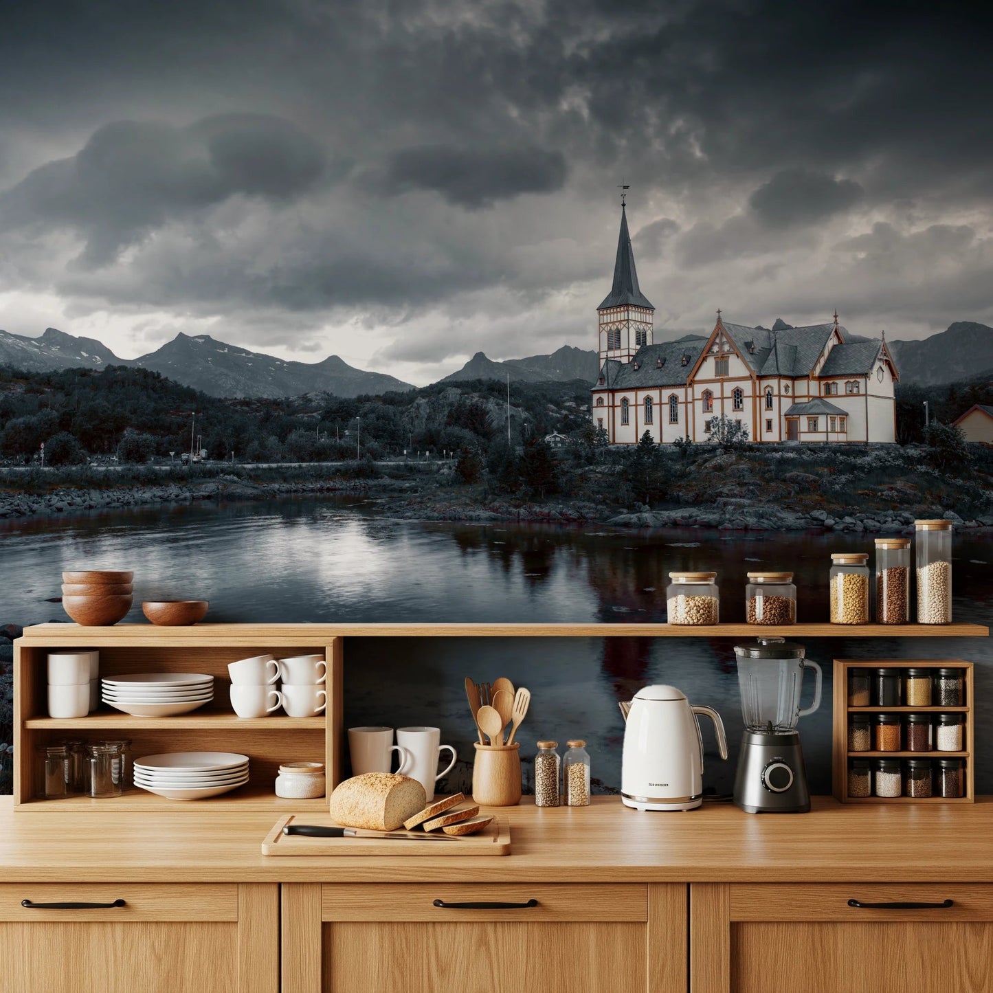 Sacred Shores wallpaper mural of a dramatic lakeside church on a kitchen wall above light wood cabinets and open shelves