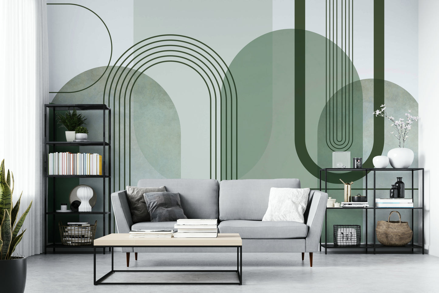 Sage Green Archways wallpaper mural behind a grey sofa and black metal shelving in a living room