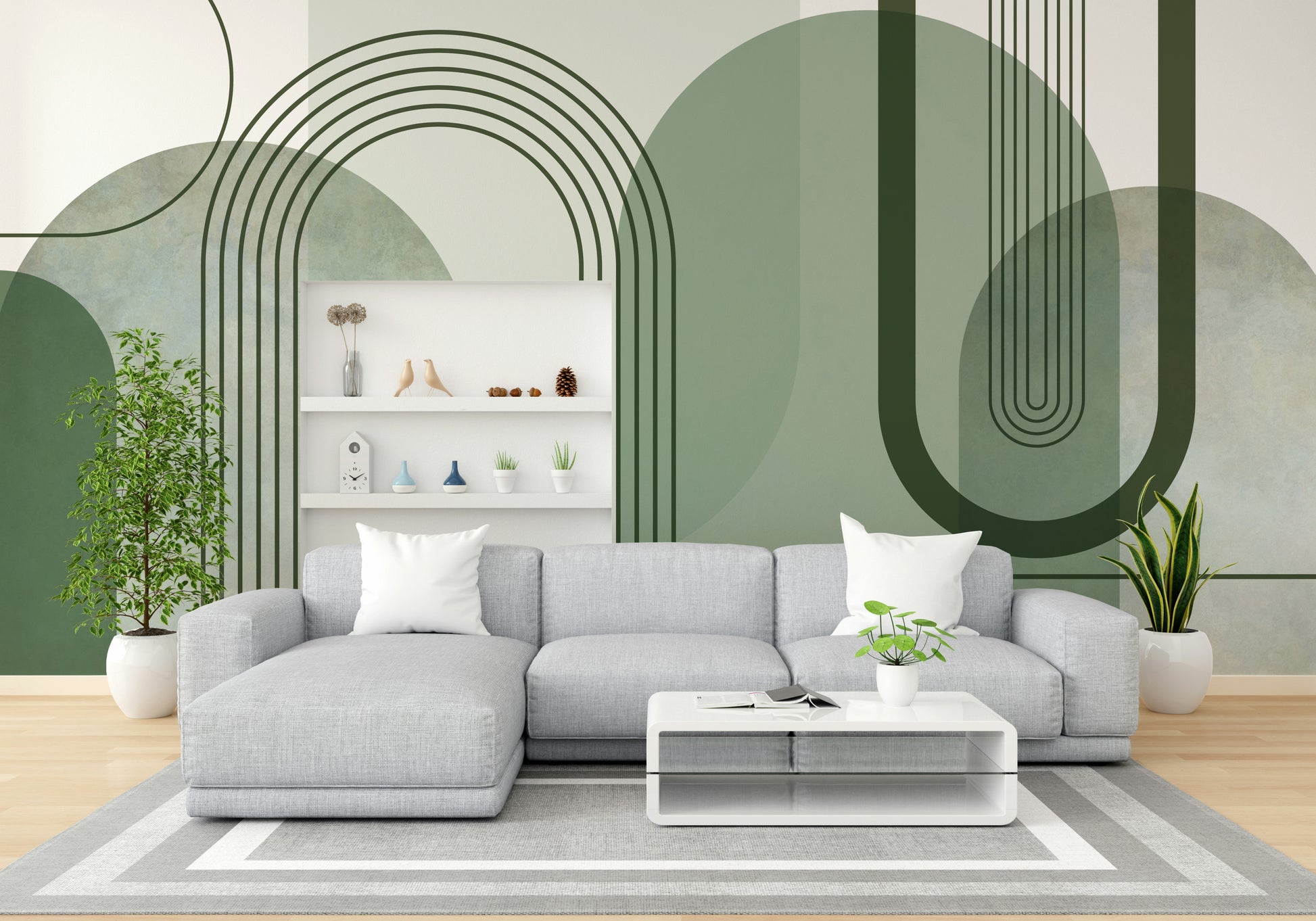 Sage Green Archways wallpaper mural behind a grey sectional sofa and white shelving unit in a living room