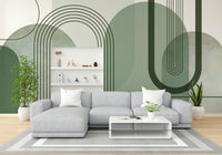 Sage Green Archways wallpaper mural behind a grey sectional sofa and white shelving unit in a living room