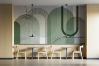 Sage Green Archways wallpaper mural in a cafe with light wood walls, small round tables and black pendant lamps