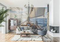 Coastal sailboat mural behind beige sofa, blue and white wall decor for apartment