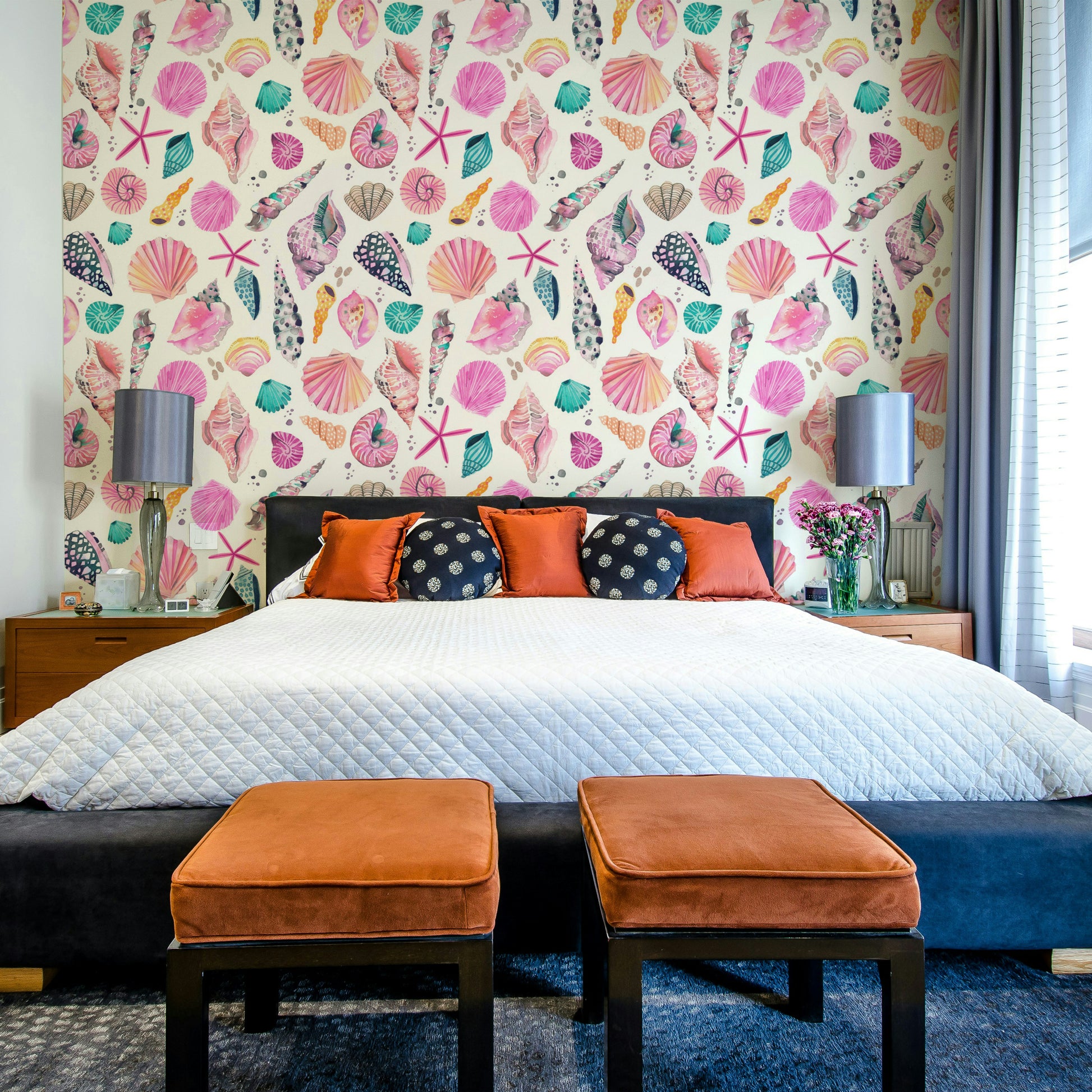 Soft pink seashell wallpaper on a light coastal background.

