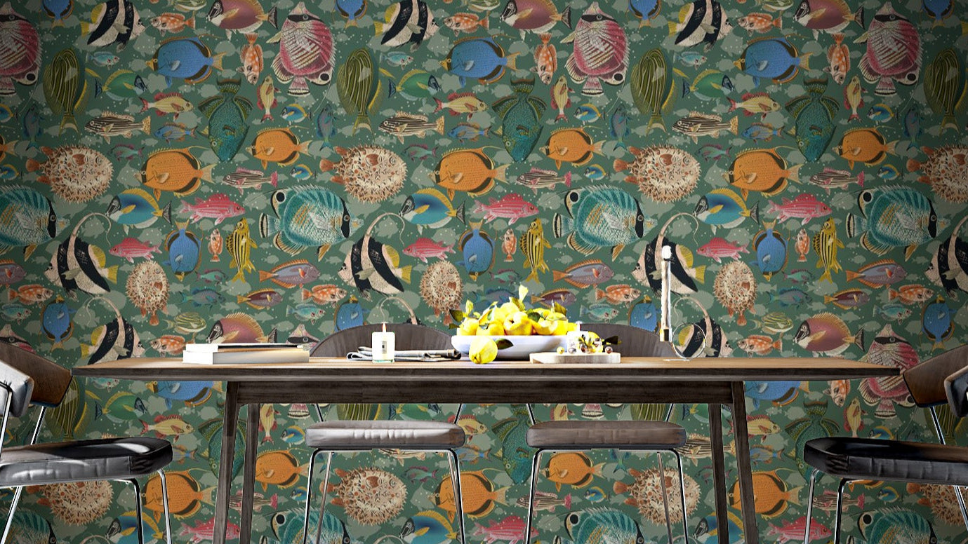 Enchanting Aquatic Dance wallpaper in green with colourful tropical fish behind a dark wood dining table and black chairs