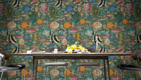 Enchanting Aquatic Dance wallpaper in green with colourful tropical fish behind a dark wood dining table and black chairs