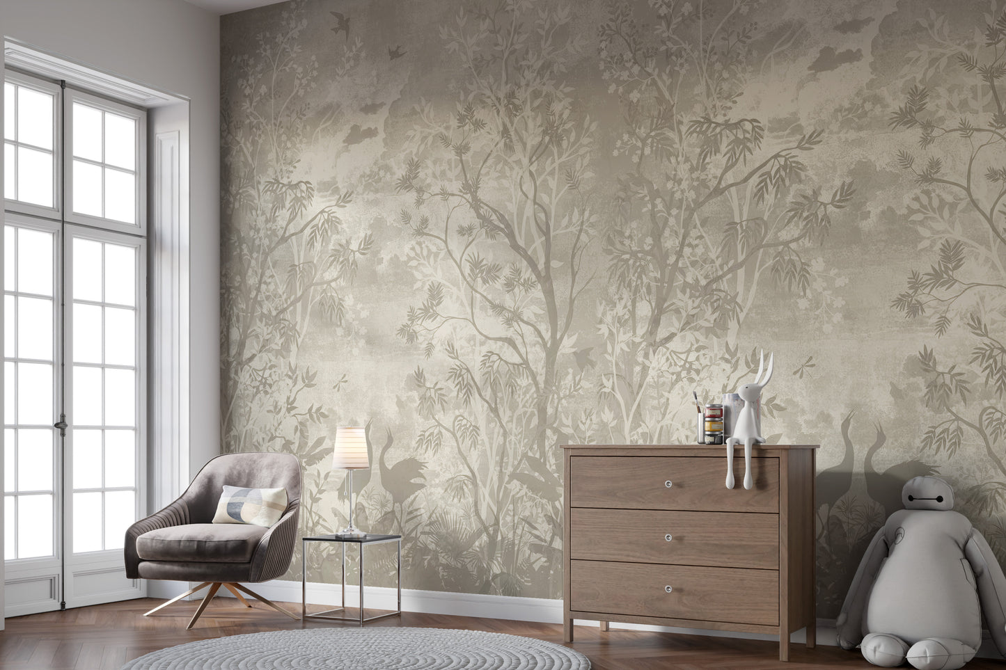 Moonlit Aves wallpaper mural in soft beige behind a grey armchair and wood dresser in a nursery