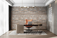 Orbit Strokes wallpaper mural of warm brown and terracotta brushstroke dots behind a wood desk in a home office