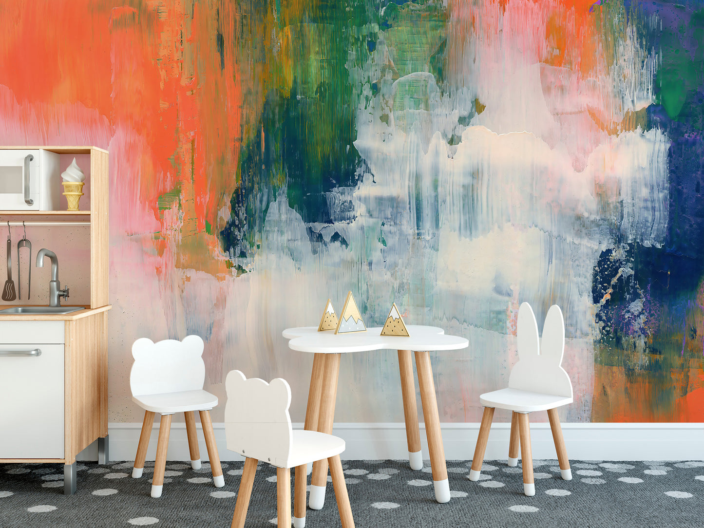 Abstract Brushstroke wallpaper mural of coral and green paint behind a white kids play table with bear chairs