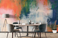 Abstract Brushstroke wallpaper mural in coral, green and blue behind a round wood dining table with grey chairs