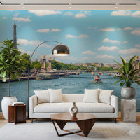 Seine Reflections wallpaper mural showing the river and bridge behind a white sofa, arc lamp and fiddle-leaf plants
