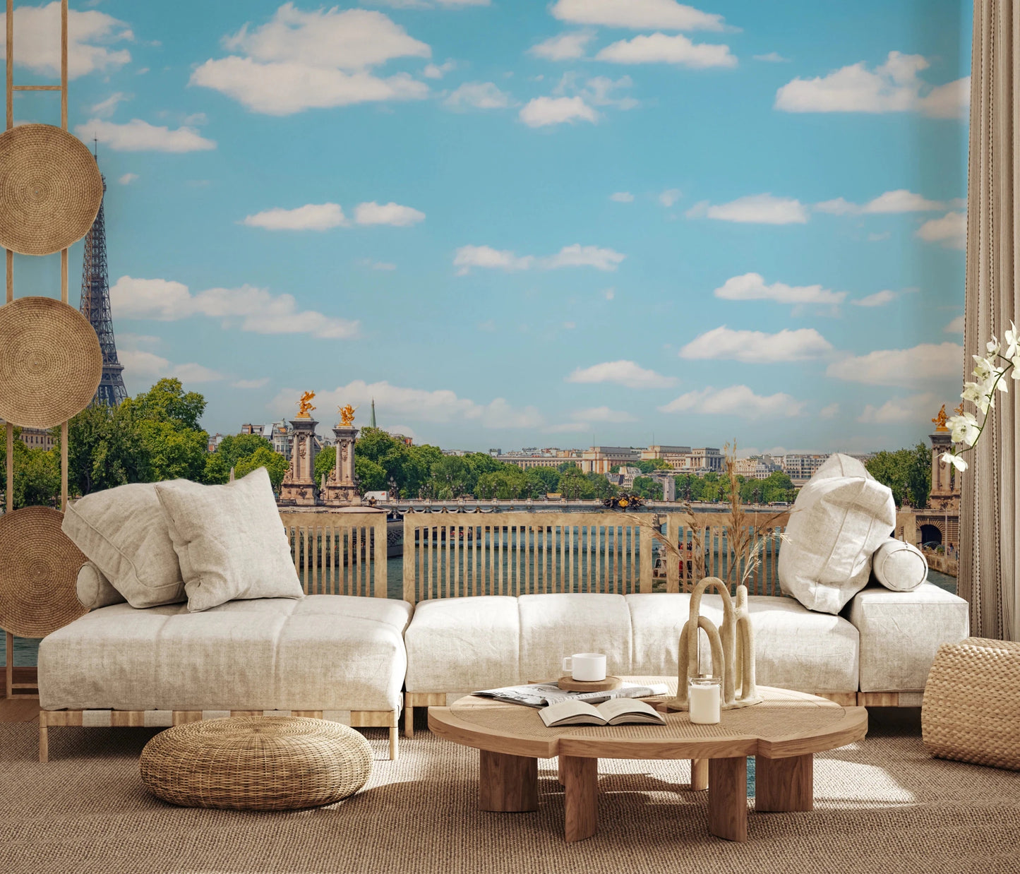 Seine Reflections wallpaper mural showing the Eiffel Tower and river behind a cream linen sofa and rattan wall discs