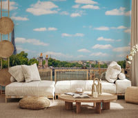 Seine Reflections wallpaper mural showing the Eiffel Tower and river behind a cream linen sofa and rattan wall discs