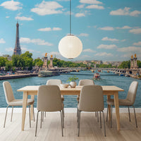 Seine Reflections wallpaper mural of Paris and the Seine behind a light wood dining table and beige chairs in a dining room