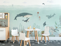 Sensational Sea wallpaper mural of whales, an orca and coral reef behind a kids play table and chairs