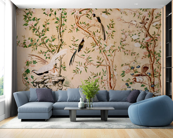Sepia Chinoiserie Chinese wallpaper mural with birds and blossoms behind a blue sectional sofa in a living room