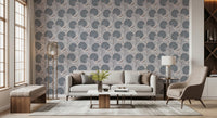 Serene Blooms wallpaper with blue-grey flowers behind a beige sofa and taupe armchair in a living room