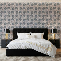 Serene Blooms wallpaper with blue-grey flowers above a black headboard and white bedding in a bedroom