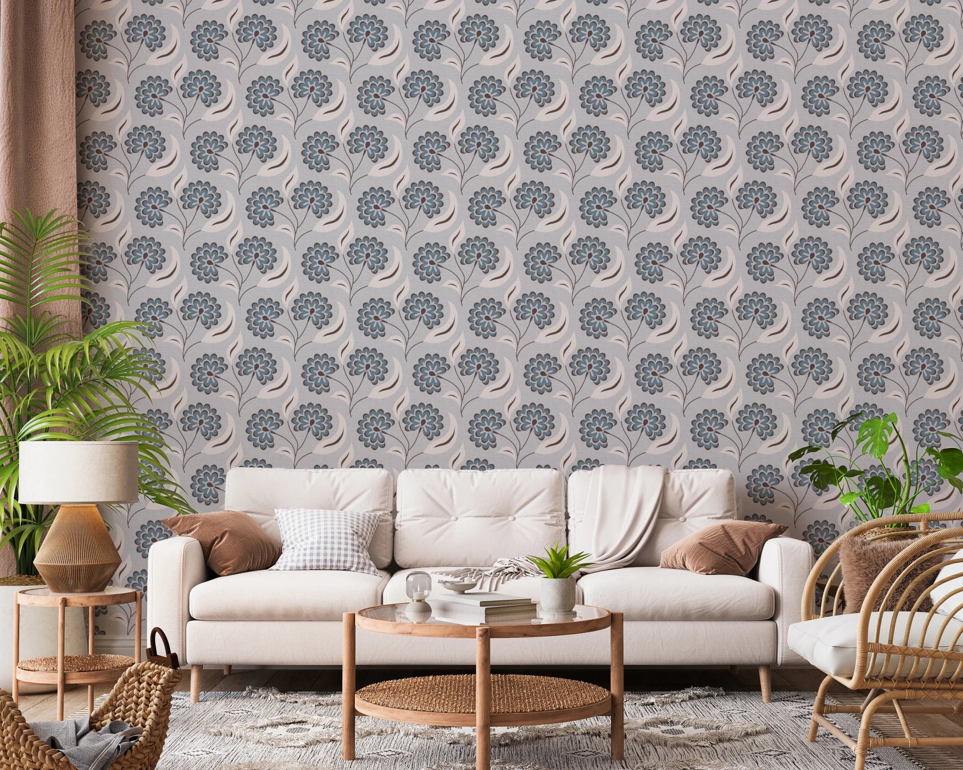Serene Blooms wallpaper with blue blooms behind a cream sofa and rattan chair framed by plants