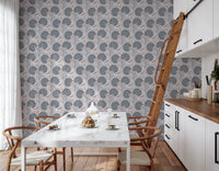 Serene Blooms wallpaper with blue floral motif behind a marble dining table in a bright kitchen
