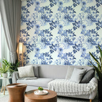 Serene Blue Botanicals wallpaper in a living room with a grey sofa and round wooden coffee tables
