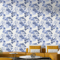 Serene Blue Botanicals wallpaper behind a mustard yellow sectional sofa in a bright living room