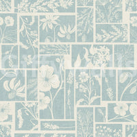 Floral patchwork wallpaper with soft blue background and botanical details