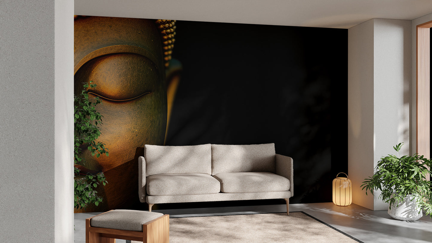Serene Buddha Sculpted Portrait wallpaper mural in gold on black behind a beige sofa with a plant in a living room