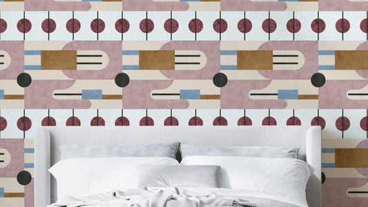 Serene Geometry wallpaper in mauve and burgundy atomic shapes behind a white upholstered bed with white linens