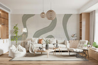 Subtle Stream wallpaper mural in sage and cream behind a cream sofa with rattan globe pendants and bean bag