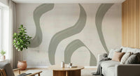 Subtle Stream wallpaper mural in sage and cream behind a grey sofa with rubber plant and wood-slat wall