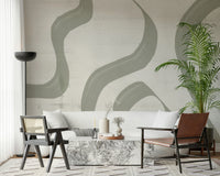 Subtle Stream wallpaper mural in sage and cream behind a cream sofa with marble table and cane chair
