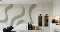 Subtle Stream wallpaper mural in sage green behind a marble kitchen island with dark bar stools