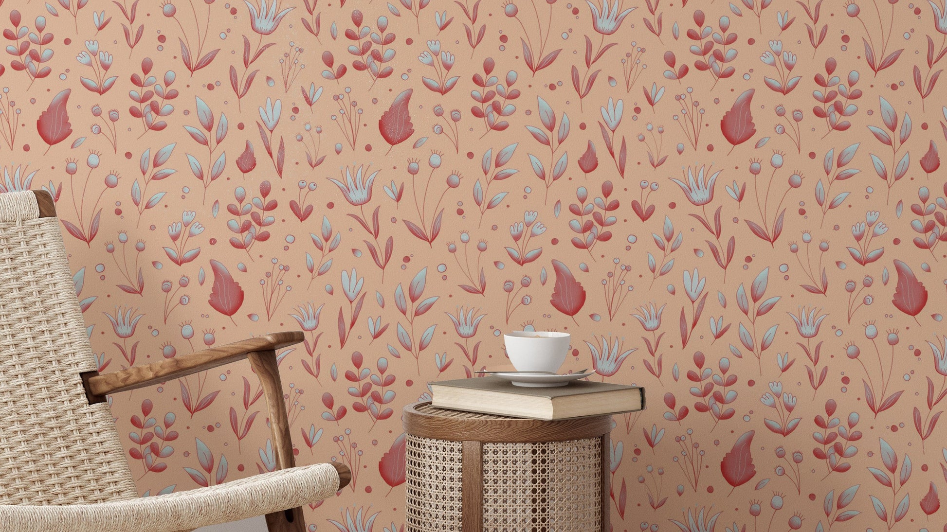 Serene Peach Tropical Garden wallpaper behind a woven cane lounge chair and round rattan side table