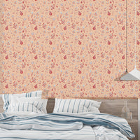 Serene Peach Tropical Garden wallpaper above a bed with blue and white striped bedding and a pendant lamp