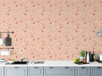 Serene Peach Tropical Garden wallpaper above a grey kitchen counter with a sink, cutting boards and peppers