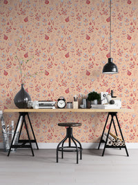 Serene Peach Tropical Garden wallpaper as a full-wall mural behind a trestle desk and stool in a home office