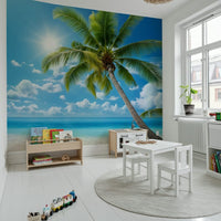 Bright living room feature wall showing quiet shoreline mural, soft blue sky, neutral sand palette
