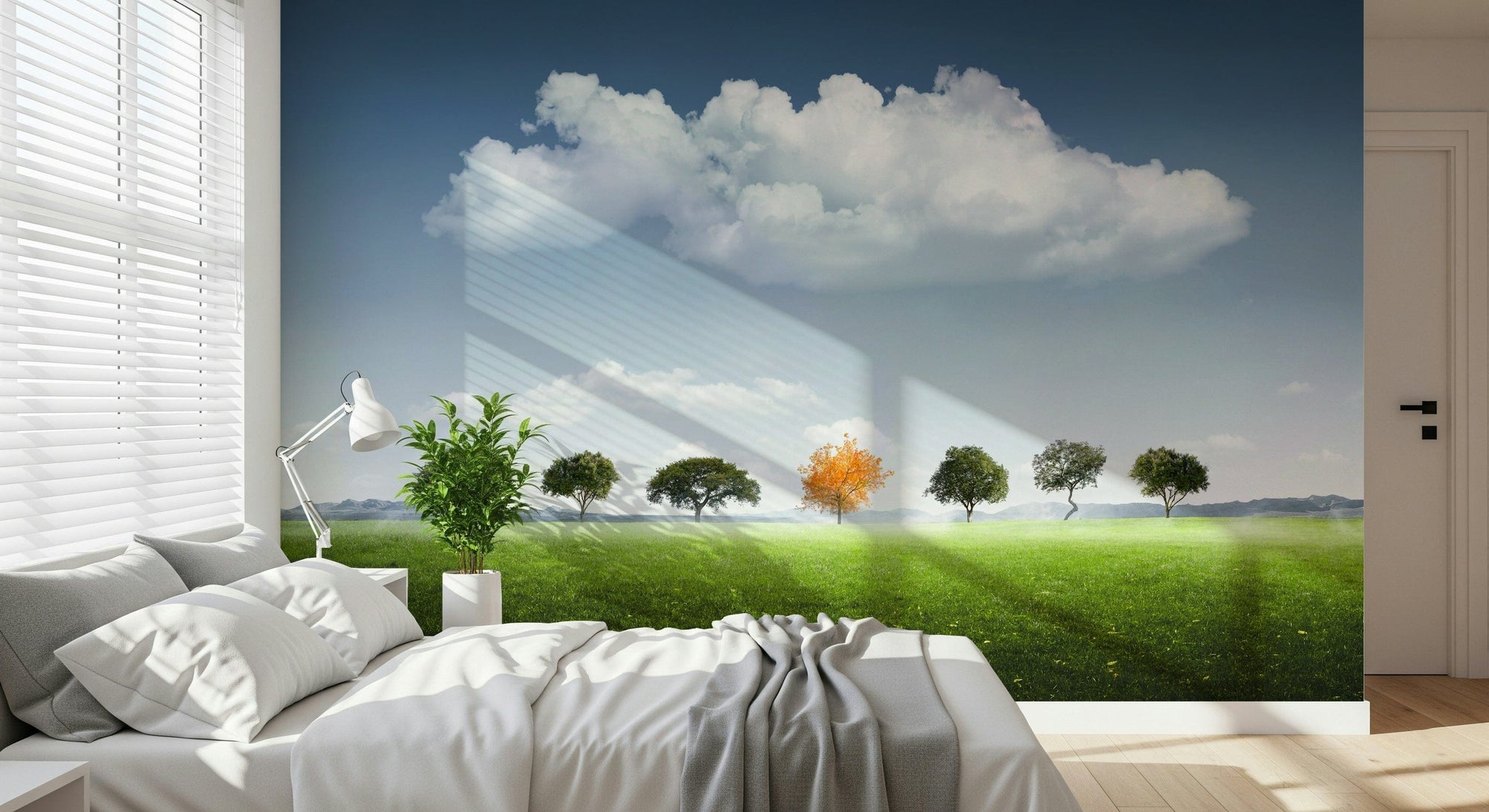 Standing Out wallpaper mural of a tree row with one orange tree on a green meadow above a white bed in a bedroom