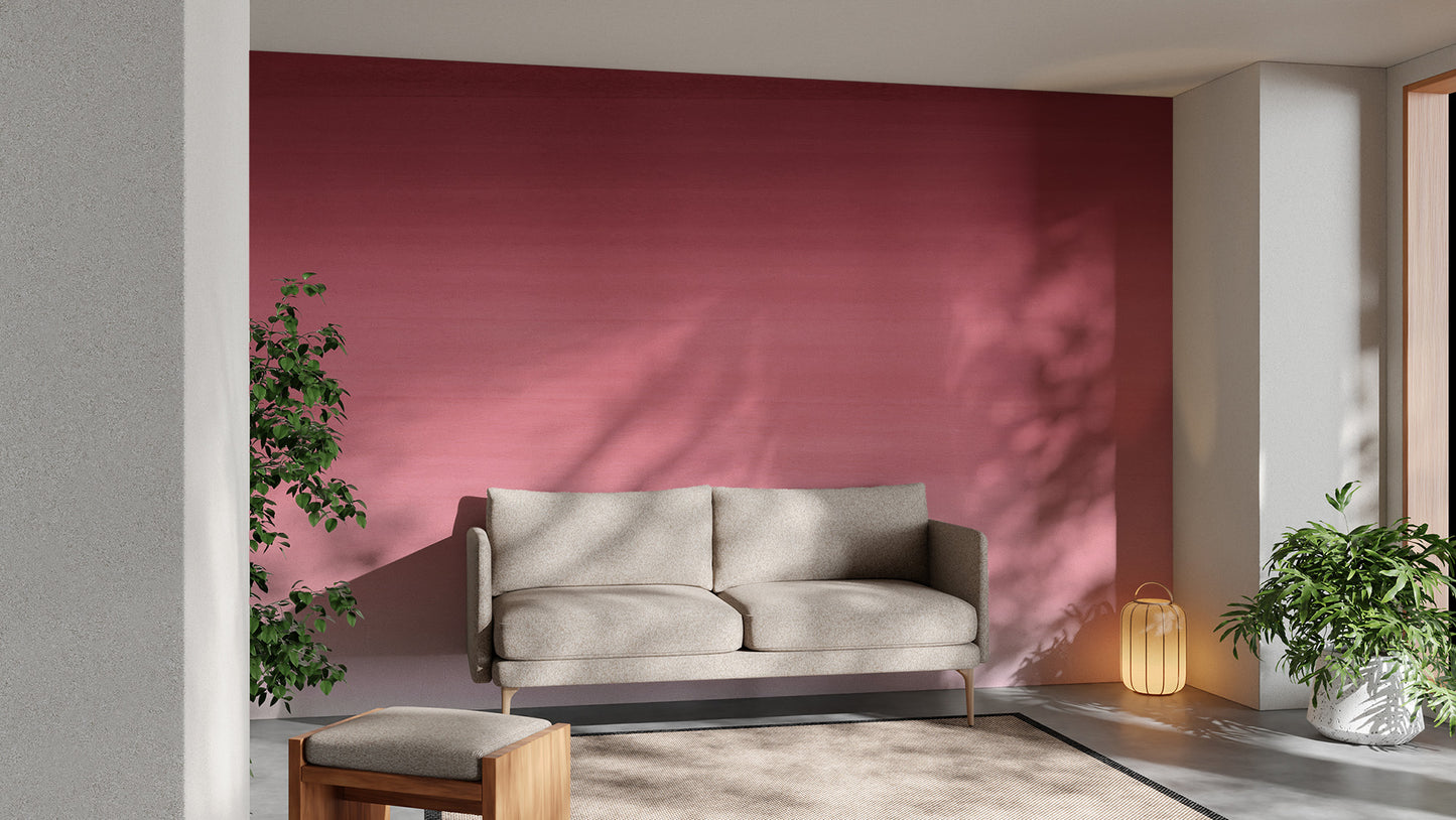 Cherry Blossom Panel wallpaper mural in pink ombre behind a beige sofa and lantern lamp in a plant-filled living room